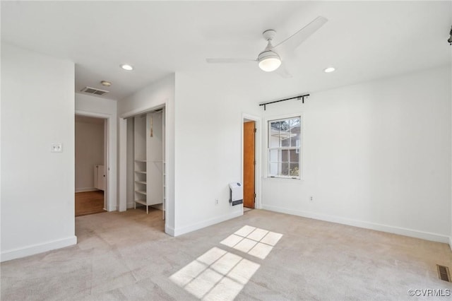 carpeted spare room with ceiling fan