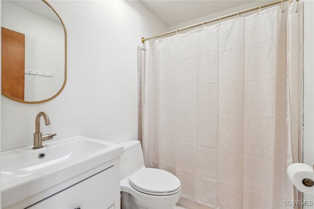 bathroom featuring vanity, walk in shower, and toilet