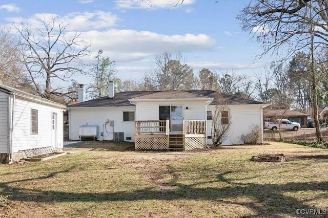 back of property featuring a wooden deck, a yard, and central AC unit