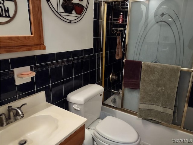 full bathroom with enclosed tub / shower combo, tile walls, vanity, and toilet