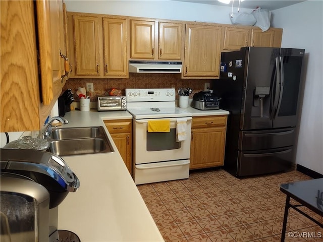 kitchen featuring white range with electric cooktop, sink, refrigerator with ice dispenser, and decorative backsplash