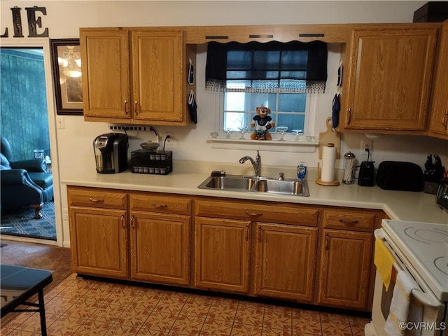 kitchen featuring sink and white range with electric stovetop