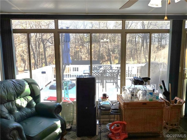 sunroom / solarium featuring ceiling fan