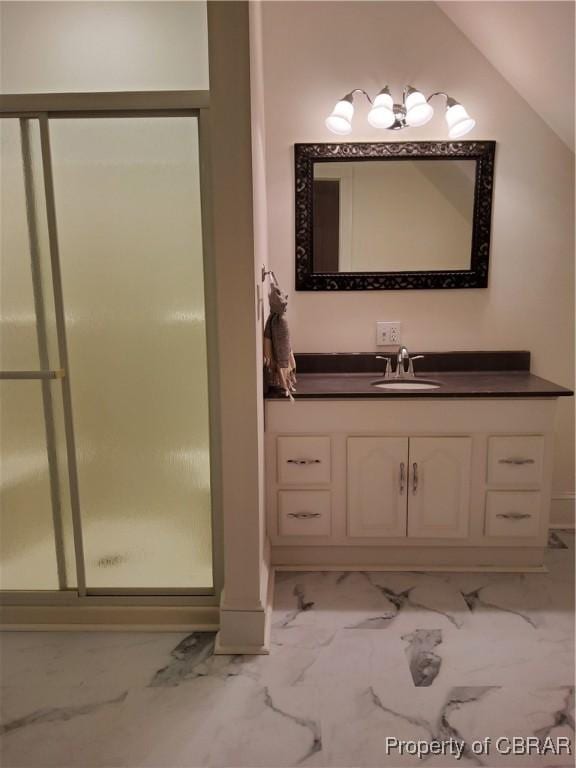 bathroom with an enclosed shower, vanity, and vaulted ceiling