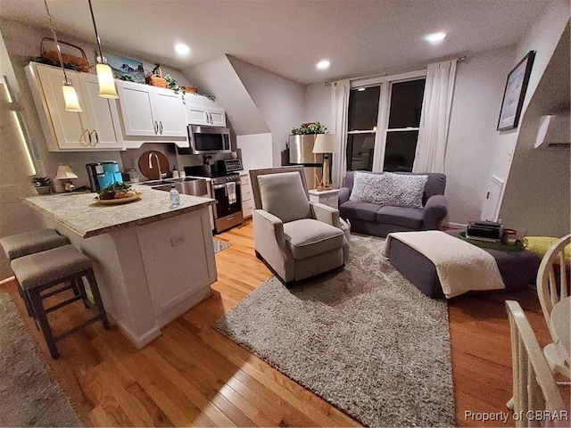 living room featuring sink and light wood-type flooring