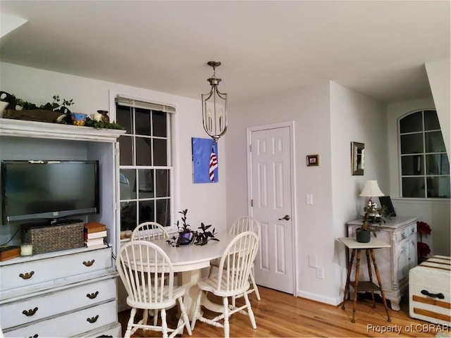 dining room featuring a notable chandelier and light wood-type flooring