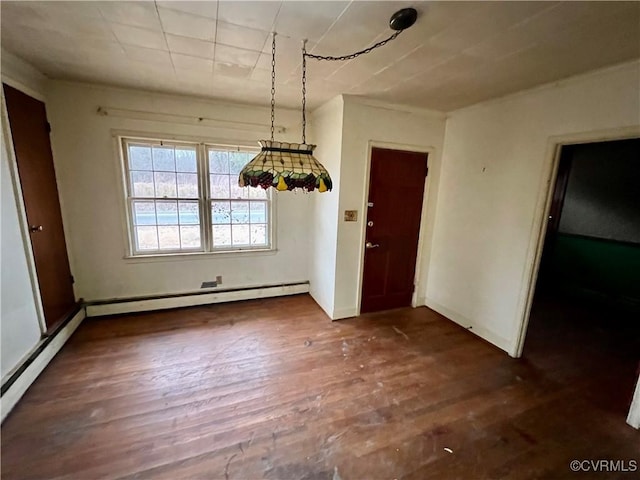 unfurnished dining area with dark wood-type flooring and a baseboard heating unit