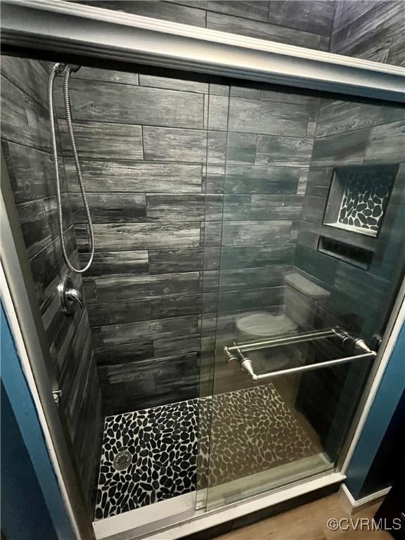 bathroom with a shower with door