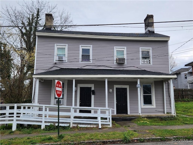 view of front facade with cooling unit and a porch