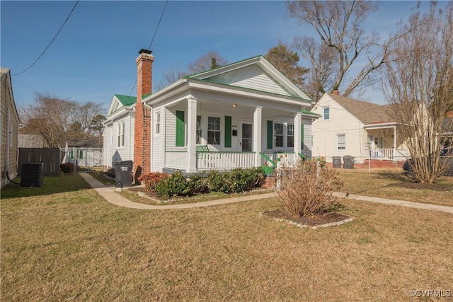 view of front facade featuring central AC, a front lawn, and a porch