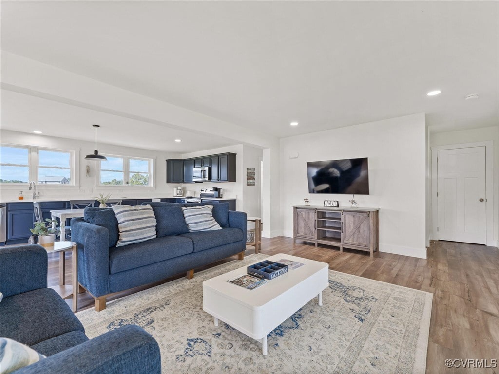 living room with sink and light wood-type flooring