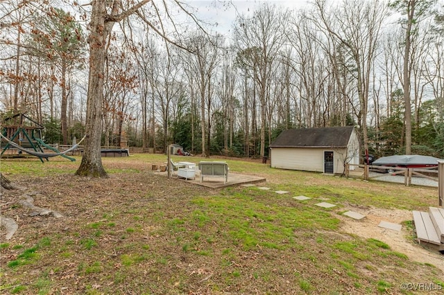 view of yard with a storage shed and a playground