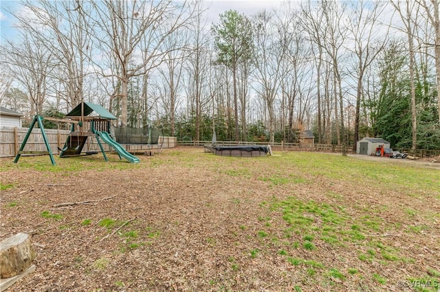 view of yard featuring a trampoline, a fenced in pool, and a playground