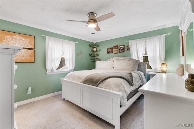 carpeted bedroom with multiple windows, ceiling fan, ornamental molding, and a textured ceiling