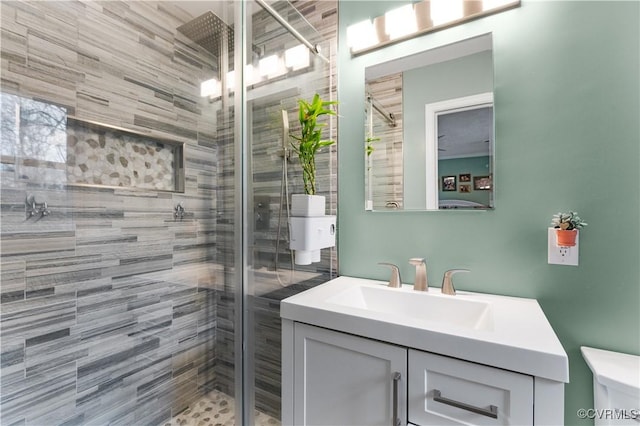 bathroom with vanity, an enclosed shower, and toilet