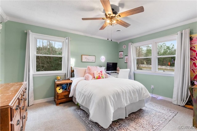 carpeted bedroom with crown molding and ceiling fan