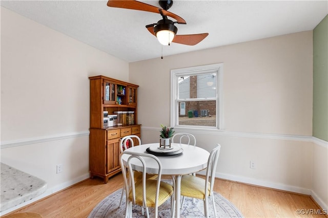 dining room with ceiling fan and light wood-type flooring