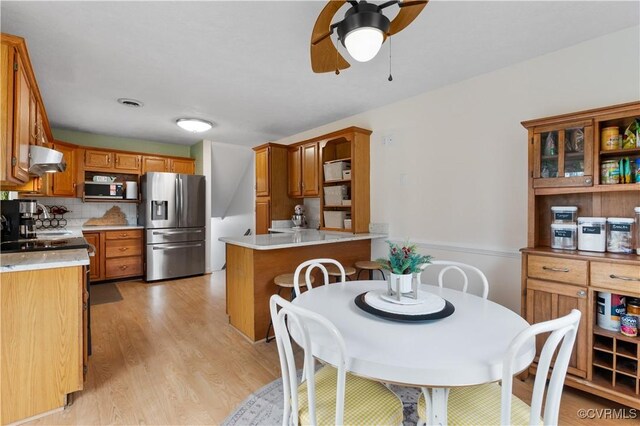 dining area featuring light hardwood / wood-style floors and ceiling fan