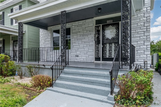 view of exterior entry with covered porch