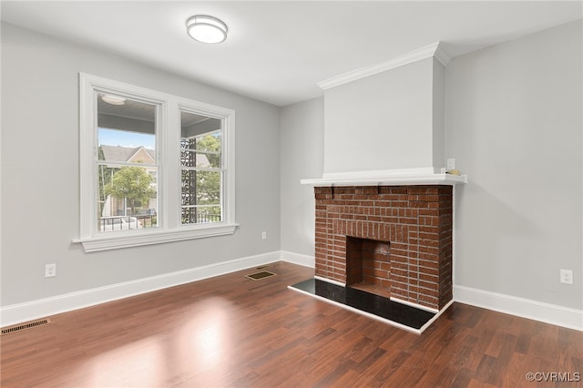 unfurnished living room featuring a fireplace and dark hardwood / wood-style floors