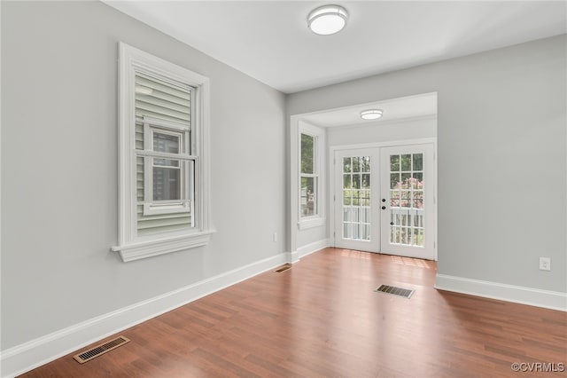 unfurnished room with french doors and hardwood / wood-style flooring