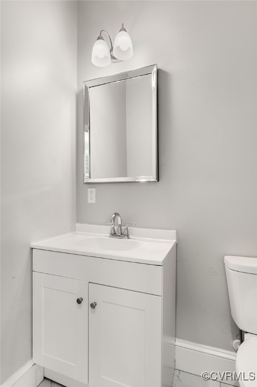 bathroom featuring vanity and toilet