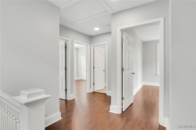 corridor with dark hardwood / wood-style flooring