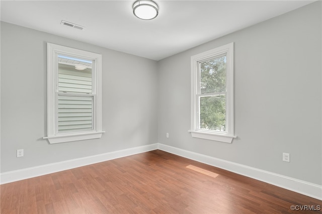 spare room with hardwood / wood-style flooring