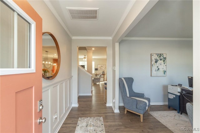 foyer entrance featuring dark wood-type flooring and ornamental molding