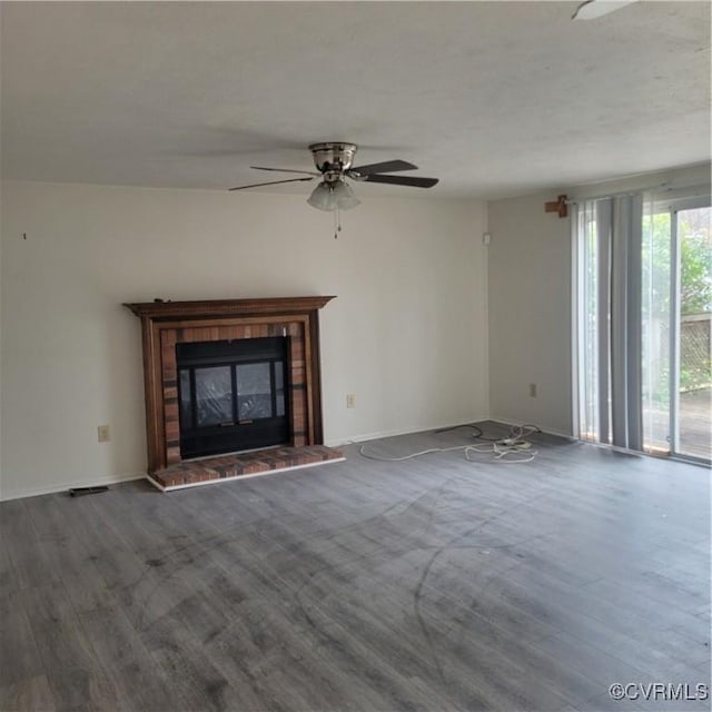 unfurnished living room featuring ceiling fan, wood-type flooring, and a fireplace