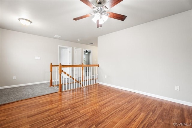 unfurnished room with hardwood / wood-style flooring and ceiling fan