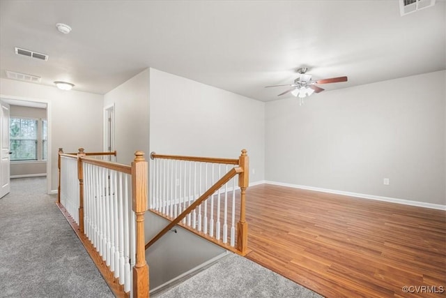 corridor with hardwood / wood-style floors