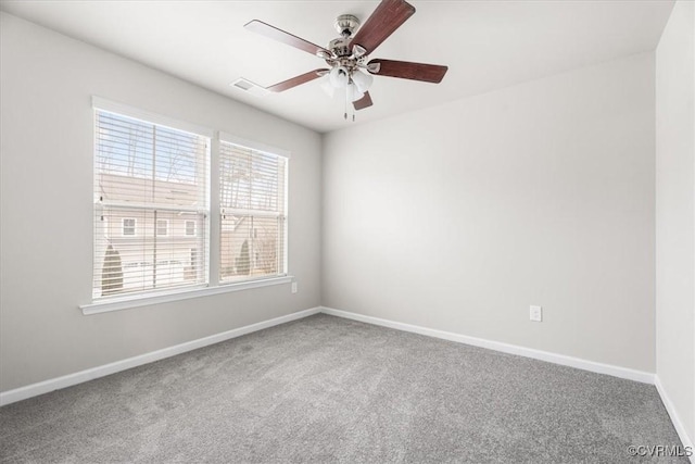 carpeted empty room featuring ceiling fan