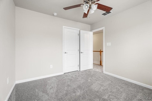 unfurnished bedroom with ceiling fan and carpet