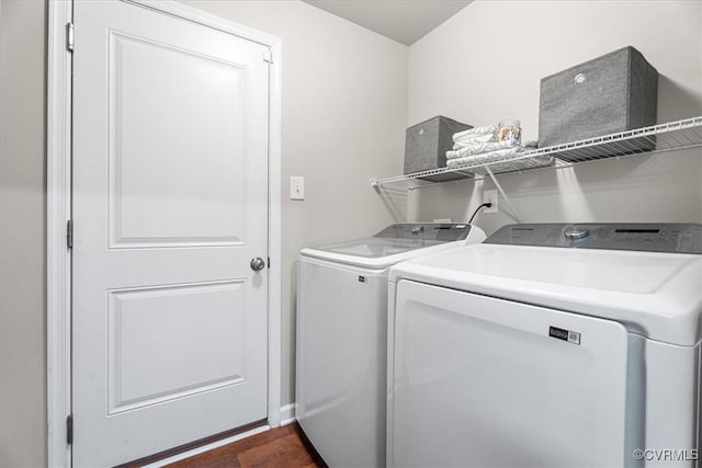 laundry area with washing machine and dryer and dark hardwood / wood-style flooring