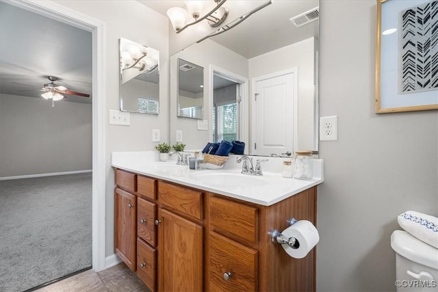 bathroom featuring ceiling fan, vanity, and toilet