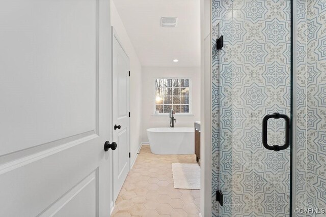 bathroom with independent shower and bath and tile patterned flooring