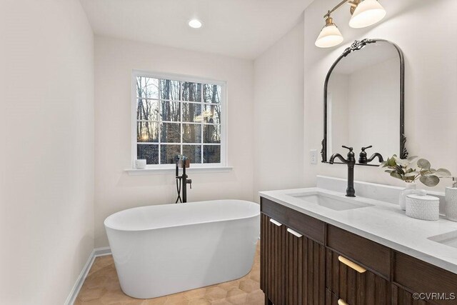 bathroom with vanity and a tub