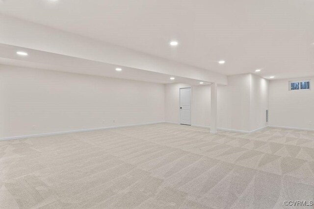 basement featuring light colored carpet