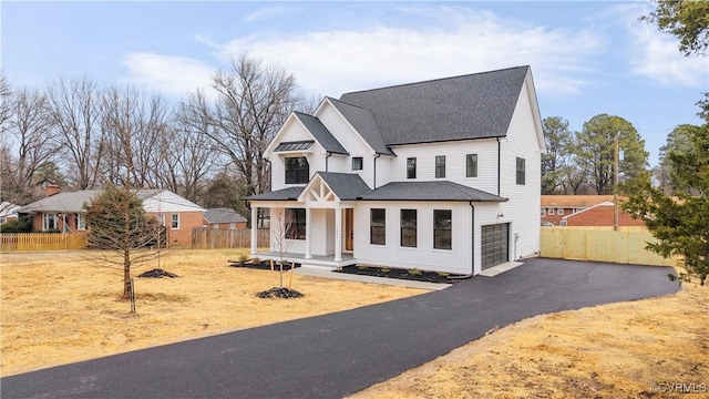 view of front of house featuring a garage and a porch