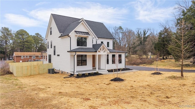 modern farmhouse featuring central AC, a front lawn, and a porch