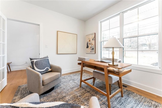 home office with hardwood / wood-style flooring