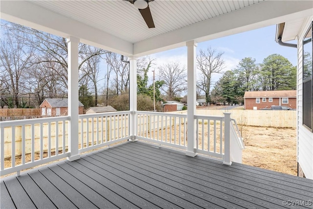 wooden terrace with ceiling fan and a shed