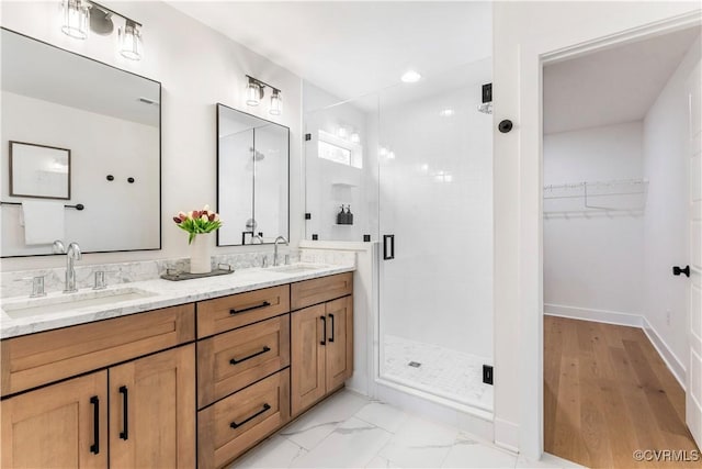 bathroom featuring vanity and a shower with shower door