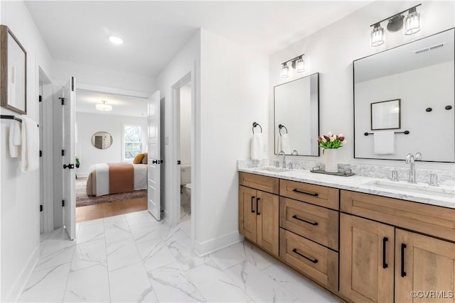 bathroom featuring vanity and toilet