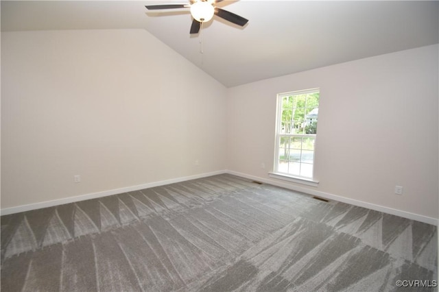 carpeted empty room featuring vaulted ceiling and ceiling fan