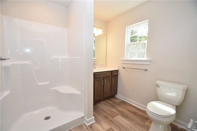 bathroom with vanity, hardwood / wood-style floors, toilet, and walk in shower