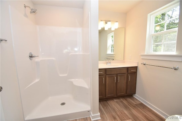 bathroom with vanity, hardwood / wood-style flooring, and a shower