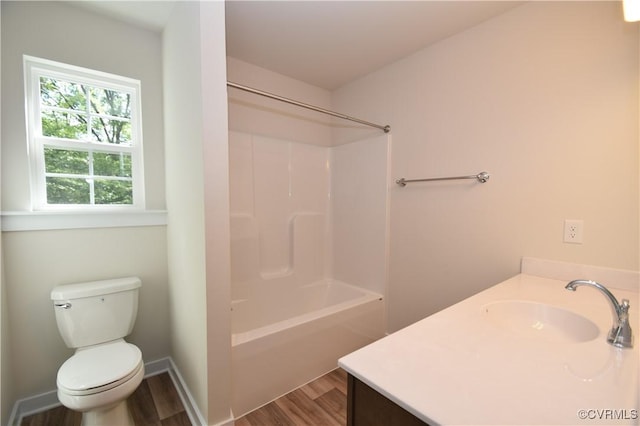 full bathroom with vanity, hardwood / wood-style floors,  shower combination, and toilet