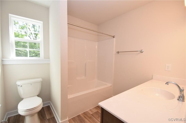 full bathroom featuring shower / washtub combination, toilet, hardwood / wood-style floors, and vanity